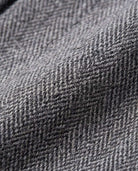 Close-up of luxurious fabric texture in gray herringbone pattern for Black Boucle Yoke Pleated Skirt.