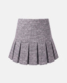 Black Boucle Yoke Pleated Skirt showcasing pleated design with yoke waistband and luxurious boucle texture.