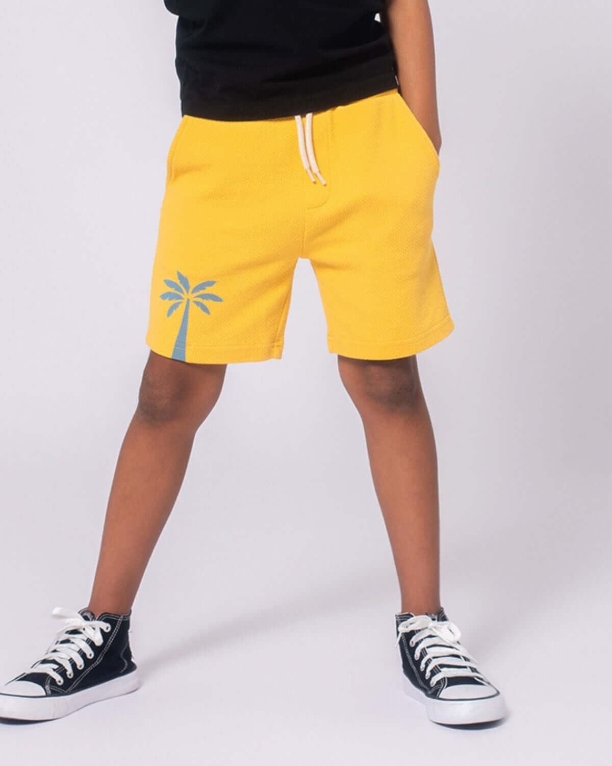 Palm Tree Resort Shorts in vibrant yellow with playful palm tree design, perfect for warm weather adventures.