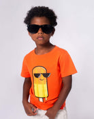 Cool kid in orange Citrus Popsicle tee and shades, ready for sunny adventures in style! Perfect for back-to-school fun.