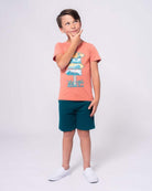 Cool kid rocking the Destination Fun Graphic Tee, ready for summer adventures with vibrant beach vibes!