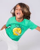 Stylish boy in green Lemon Aid graphic tee, brightening days with Lenny the Lemon's cheerful spirit! Ideal kids clothes, back to school.