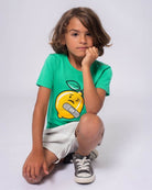 Stylish kid in a lemon graphic tee, showcasing playful design—perfect for back-to-school fun in high-quality kids clothes.