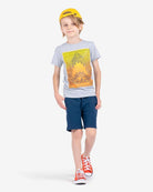 Stylish kid in a shark graphic tee and shorts, ready for back to school in high-quality kids clothes that are fun and durable.