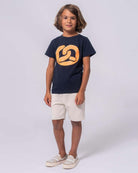 Boy in navy Pretzel Graphic Tee and shorts, showcasing comfy kids clothes—ideal for school or playtime adventures!