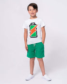 Cheerful boy in Recharged Graphic Tee with battery design, ready for fun in stylish kids clothes for back to school.