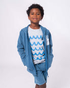 Stylish boy rocking a Waves Graphic Tee paired with a cozy hoodie, ready for adventure in high-quality kids clothes.