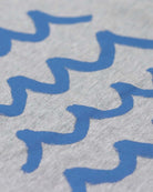 Close-up of playful blue wave pattern on soft graphic tee, perfect for stylish kids' casual wear.