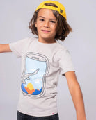 Adventurous boy wearing a playful window seat graphic tee, showcasing fun kids clothes for travel-inspired style.