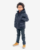 Stylish boy in a black Summit Puffer Coat, standing confidently, perfect for trendy kids and back-to-school adventures.