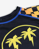 Vibrant long sleeve rash guard for kids, featuring playful palm tree design and funky checkerboard sleeves.