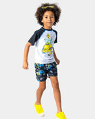 Stylish kid in Lemon Chill Swim Trunks, ready for fun and sun with UPF 50+ protection—perfect for back to school adventures!