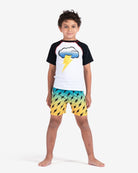 Stylish kid in Storm Cloud Rash Guard, ready for waves with sun protection and thunderstorm vibes – perfect for adventurous days!