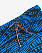Vibrant blue wave-pattern swim trunks with an elastic waistband, perfect for stylish kids' beach days.