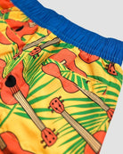 Vibrant ukulele-patterned swim trunks with a blue waistband—perfect for stylish kids' beach days!