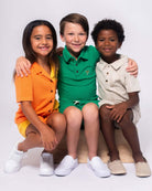 Three stylish kids showcase vibrant, high-quality boys and girls clothes—perfect for back to school adventures!