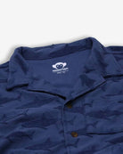 Navy resort shirt with playful shark print for boys, showcasing fun style and breathable fabric for summer adventures.