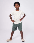 Stylish boy rocking a Palms Concert Tee, showing off vibrant palm prints and comfy shorts—perfect for sunny adventures!