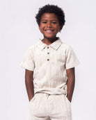 Stylish boy in a playful patterned polo, showcasing high quality kids clothes perfect for back to school fun.