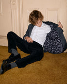 Boy in a stylish Professor Plaid Club Jacket reveals fun scientist-themed lining, showcasing upscale back to school kids clothes.