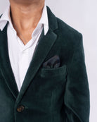 Evergreen Velvet Suit Set featuring a deep forest green blazer and white shirt with a stylish pocket square.