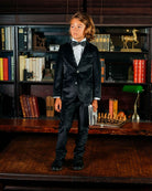 Stylish kid in a black velvet suit blazer, ready to shine at the holiday party or school event—high-quality boys and girls clothes.