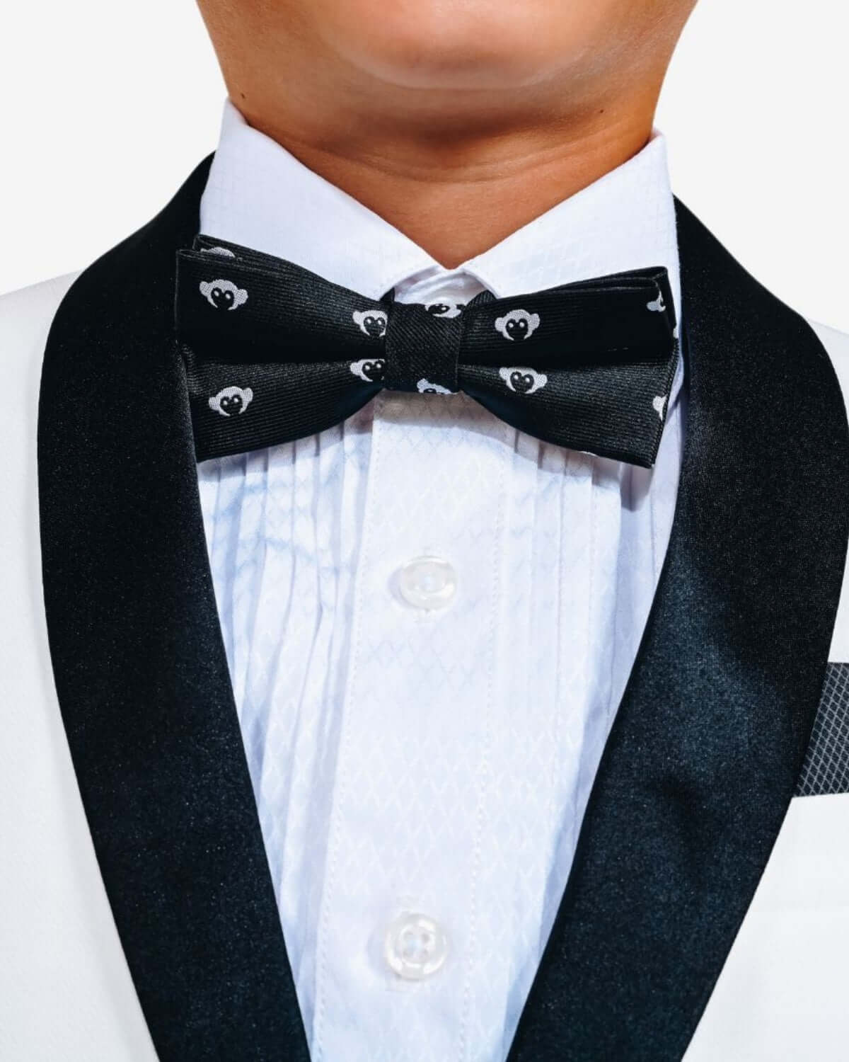 Black Logo Bow Tie worn by a child with a tuxedo, featuring playful logo design on a black background.
