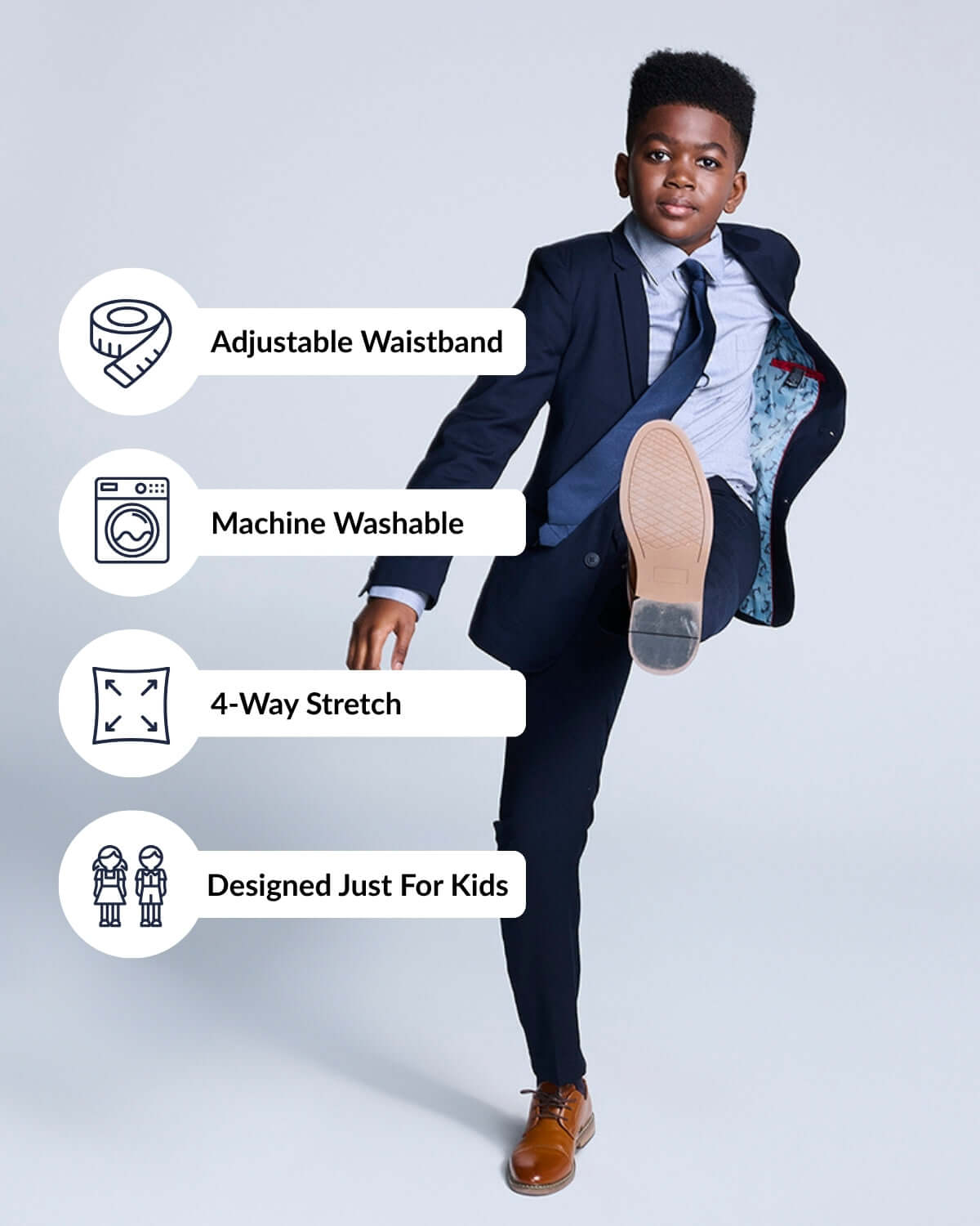 Boy wearing Navy Blue Mod Suit demonstrating adjustable waistband, machine washable fabric, and 4-way stretch features.