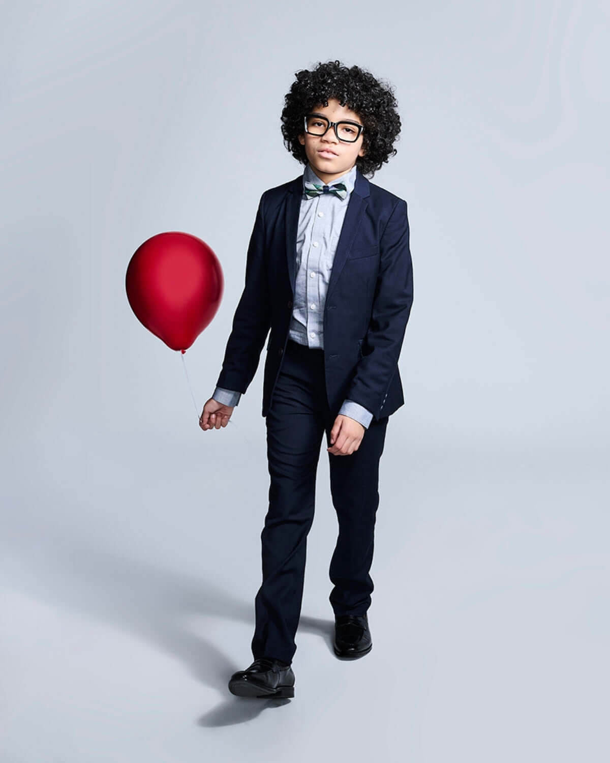 Boy wearing Navy Blue Suit Pants, stylishly holding a red balloon, showcasing a formal look perfect for special occasions.
