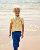 Sunny smiles in a vibrant lemonade party shirt, ready for beach fun—stylish kids clothes for adventurous boys!