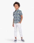 Cute boy in a navy floral party shirt, styled for fun festivities and back to school adventures. High-quality kids clothes!