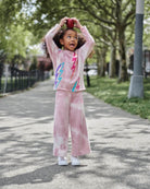 Stylish girl rocking Lightning Bolt Samantha Sweatpants, playful in pale pink tie-dye and fun lightning designs.