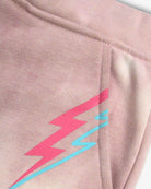 Close-up of playful lightning bolt design on pink marble Samantha Sweatpants, perfect for stylish kids.