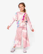 Stylish kid rocking the Lightning Bolt Samantha Sweatpants in pink marble tie-dye with playful lightning designs!