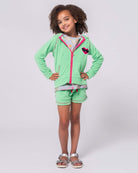 Stylish girl wearing mint Majorca shorts with a matching hoodie, perfect kids clothes for fun summer adventures!