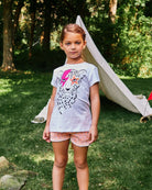 A cool kid rocking Appaman's fun cheetah tee and playful multicolor shorts, perfect for outdoor adventures!