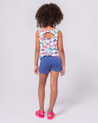 Stylish girl in floral tank and navy sparkle shorts, ready for summer fun in high-quality kids clothes!