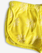 Cheerful summer daisy print terry shorts for kids, featuring comfy pockets and playful adjustable drawstring.