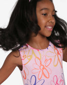 A joyful girl twirls in a colorful Daisy Naxios Dress, embodying summer fun in high-quality kids clothes.
