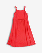 A vibrant neon orange Carrie Dress for girls, featuring a fun back cut-out and sunny vibe—perfect for summer adventures!