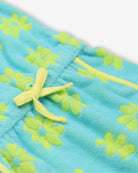 Close-up of the playful blue Mia Dress featuring cheerful daisy print and drawstring detail—stylish kids clothes for adventure!