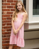 Confident girl in stylish Pink Gold Madison Dress, twirl-ready for fun days in high-quality kids clothes!