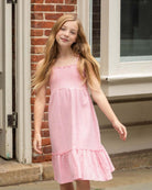 A girl twirls in the playful Pink Gold Madison Dress, showcasing its chic design and twirl-ready skirt for fun days out!