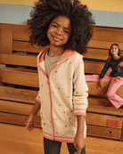 Stylish kids in heart-patterned Cozy Raglan Hoodie, perfect for back to school fun and everyday adventures.