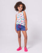 Bright and cheerful girl in butterfly print Hazel Top, paired with comfy shorts for stylish kids clothes.