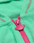 Close-up of playful pink zipper on a mint green hoodie, adding style to kids clothes for school or casual playdates.