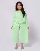 Stylish girl in mint green beach sweater and matching pants, perfect for sunny days and playful adventures in kids clothes.