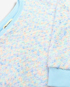 Soft confetti-like pastel kids top with blue cuffs, perfect for back to school fun in stylish comfort!