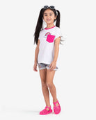 Stylish girl in a rainbow pocket tee and shorts, ready for fun adventures in high-quality kids clothes.
