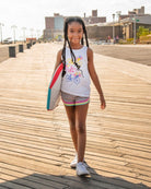 Stylish girl in a bright bicycle print tank top and shorts, ready for summer fun in high-quality kids clothes.